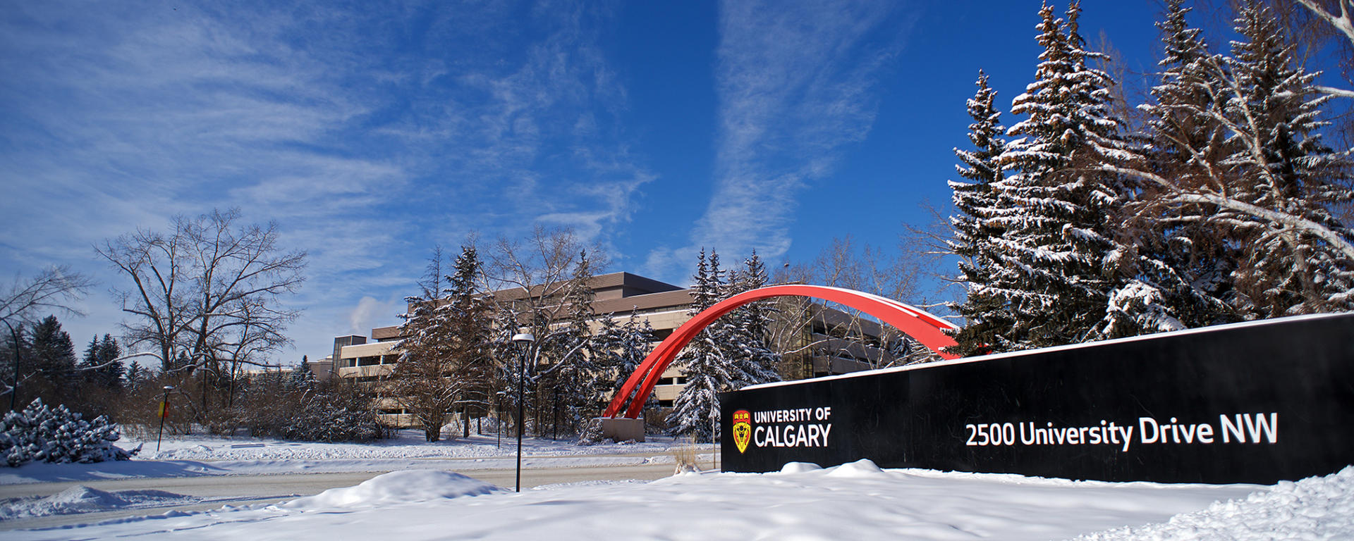 Winter on U of C Main Campus with Large U of C sign and archway in the background