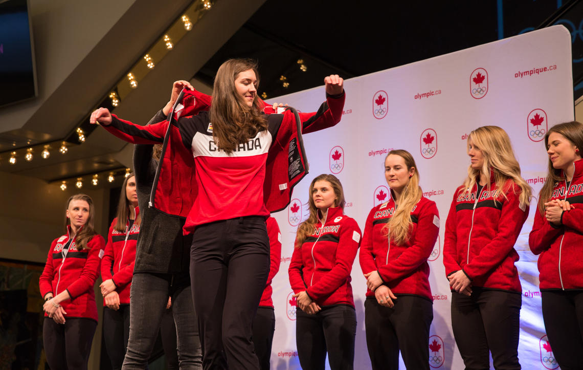 Isabelle Weidemann tries on her Team Canada jacket at the announcement event in early January.