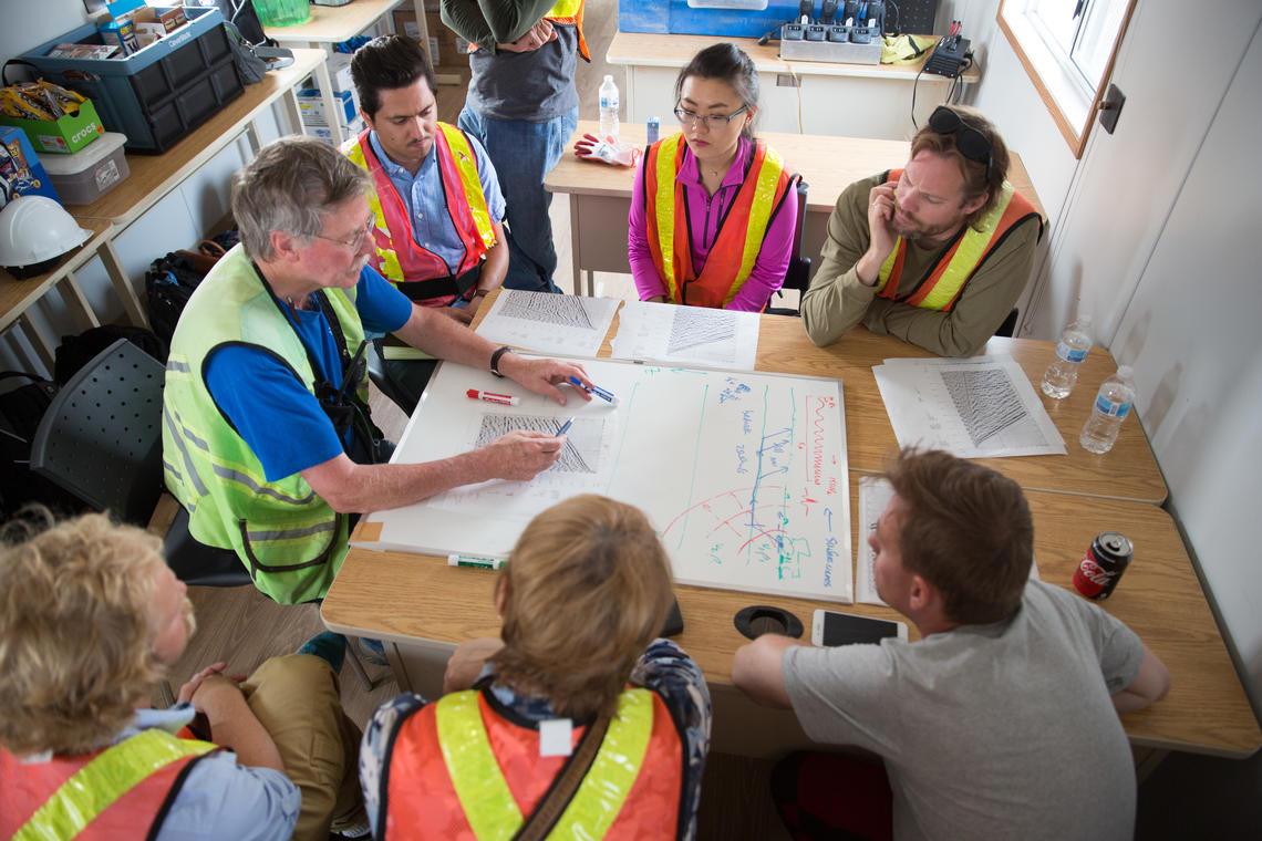 Don Lawton, left, explains the results of seismic waves to UCalgary and NTNU researchers at the CaMI field research station. 