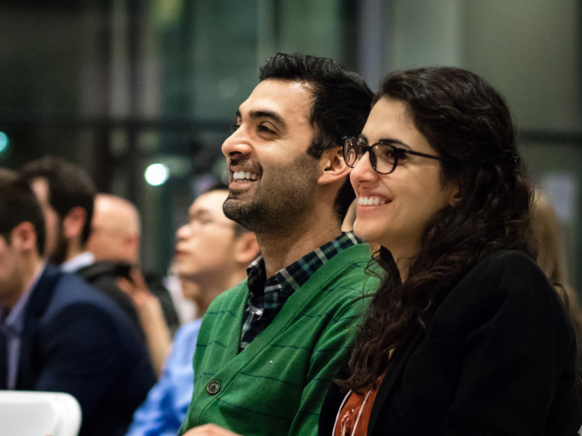 Ashkan Tehrani and Negar Mohammadi look on during the award ceremony at the Innovation4Health Hack Competition.