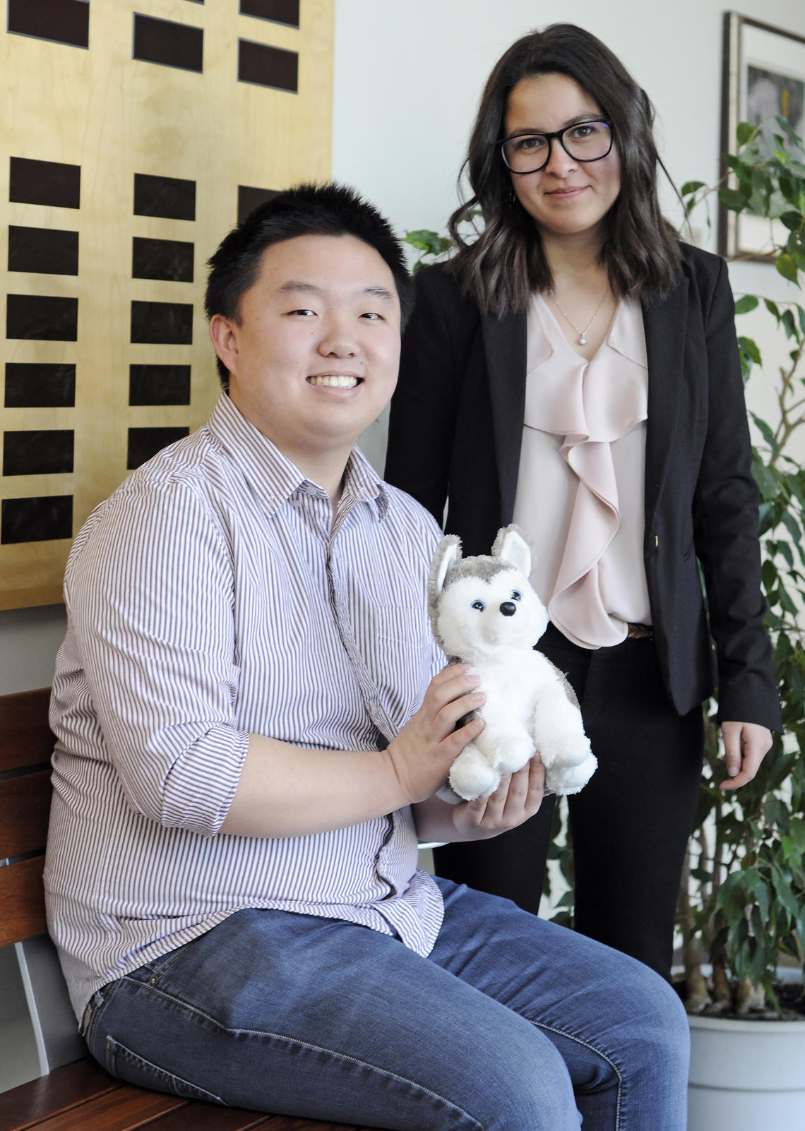 Pack members Wentao Li, left, and Manel Djebrouni with the group's Husky stuffed animal, which has become a symbol for the WolbPack. 