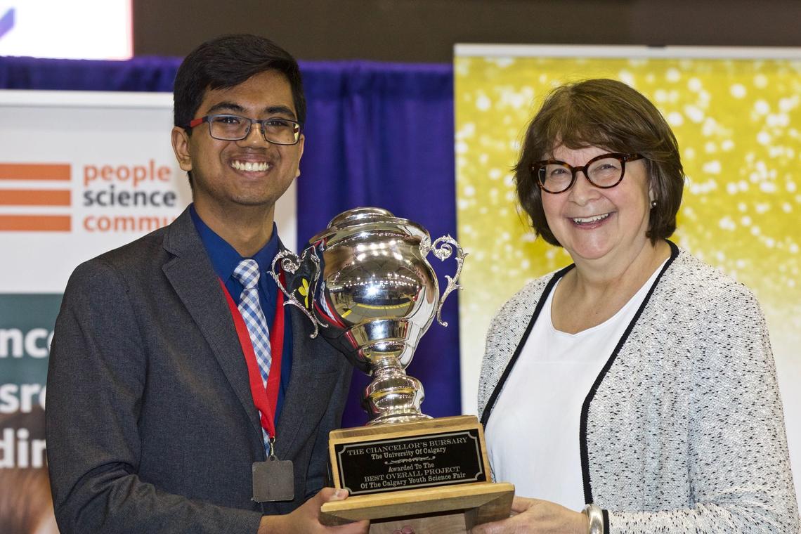 Grade 12 Sir Winston Churchill High School student Mehul Gupta receives the university's top prize - the Chancellor's Bursary, valued at $2,500 - from Chancellor Emerita Joanne Cuthbertson