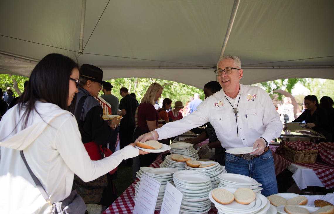 President Ed McCauley serves up barbecue at the annual President’s Stampede Barbecue on July 3. 