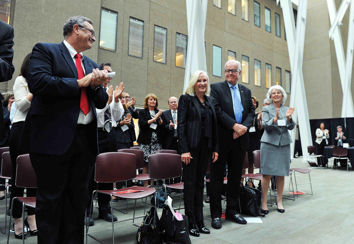 Dr. Jon Meddings, left, dean of the Cumming School of Medicine, and Bonnie DuPont, right, chair of the University of Calgary Board of Governors, join the audience in applauding the O'Briens for their generous gift Tuesday. 