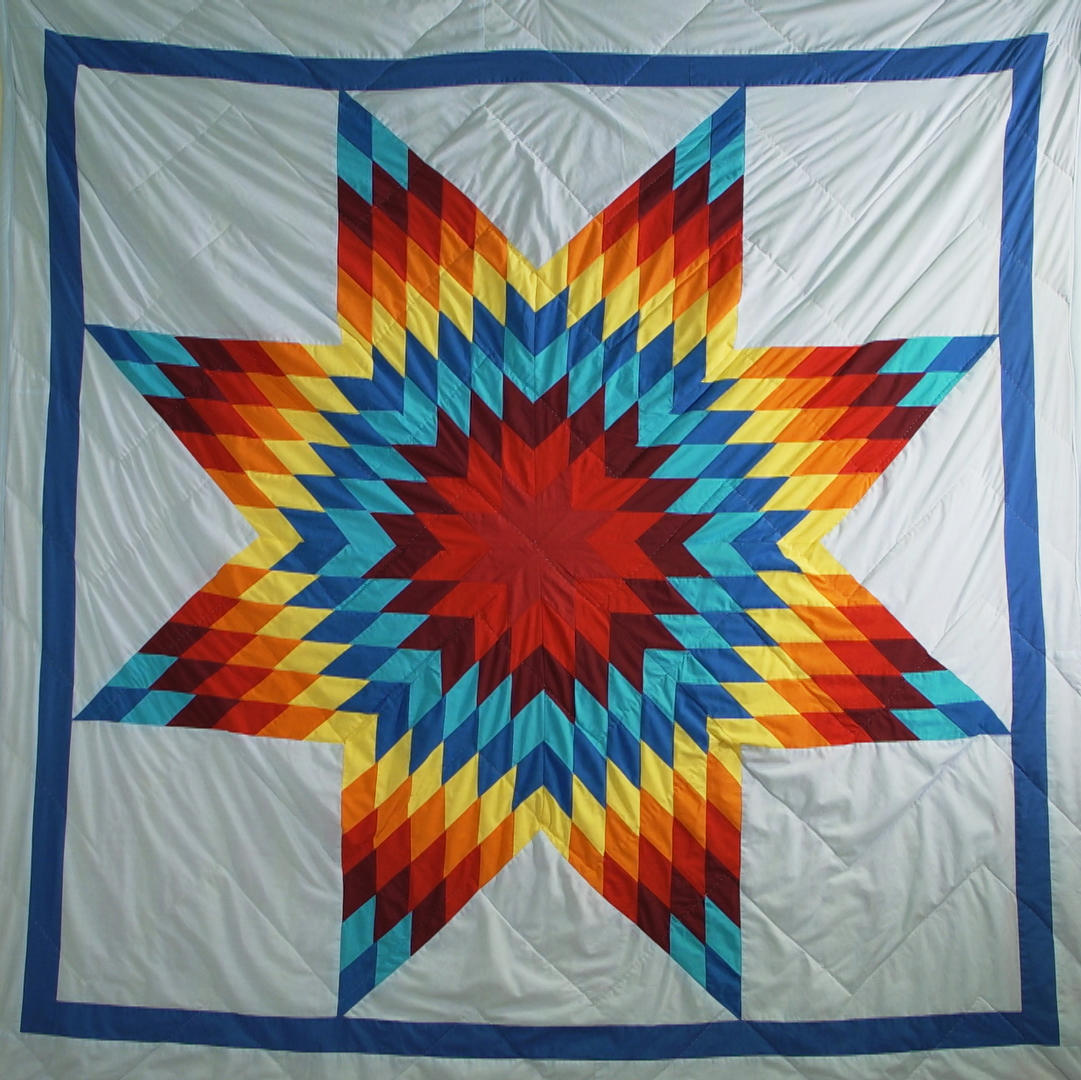 When Whitney Ogle graduated with her first post-secondary degree, her family honoured her with this star quilt after it had been blessed and smudged.