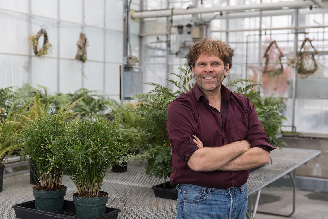 Peter Facchini stands in the greenhouse in the Faculty of Science