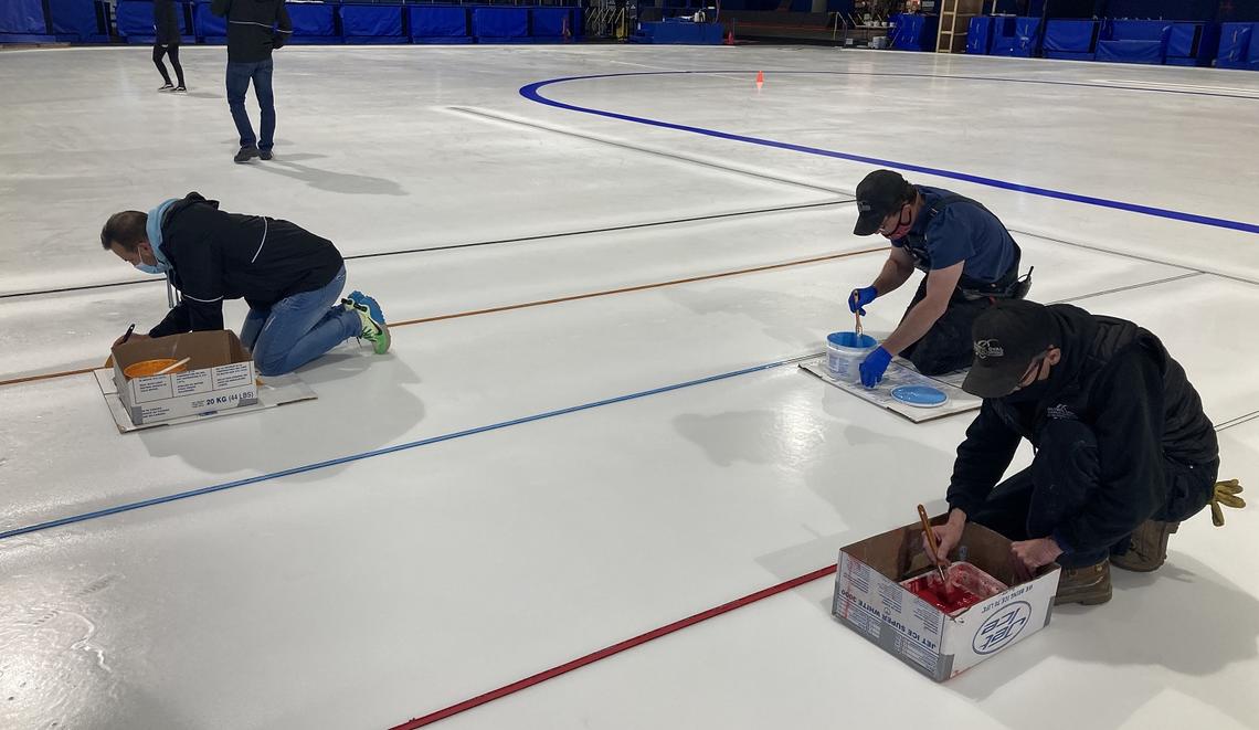 Olympic Oval operations team painting lines on the ice