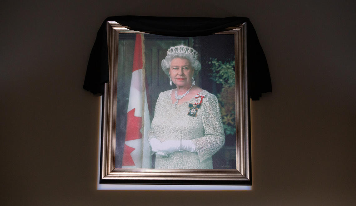 Draped in black, an official portrait of Queen Elizabeth II hangs in the Atrium at The Military Museums of Calgary.