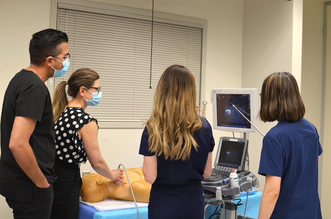 Group of physicians training on the Point-of-care Ultrasound equipment