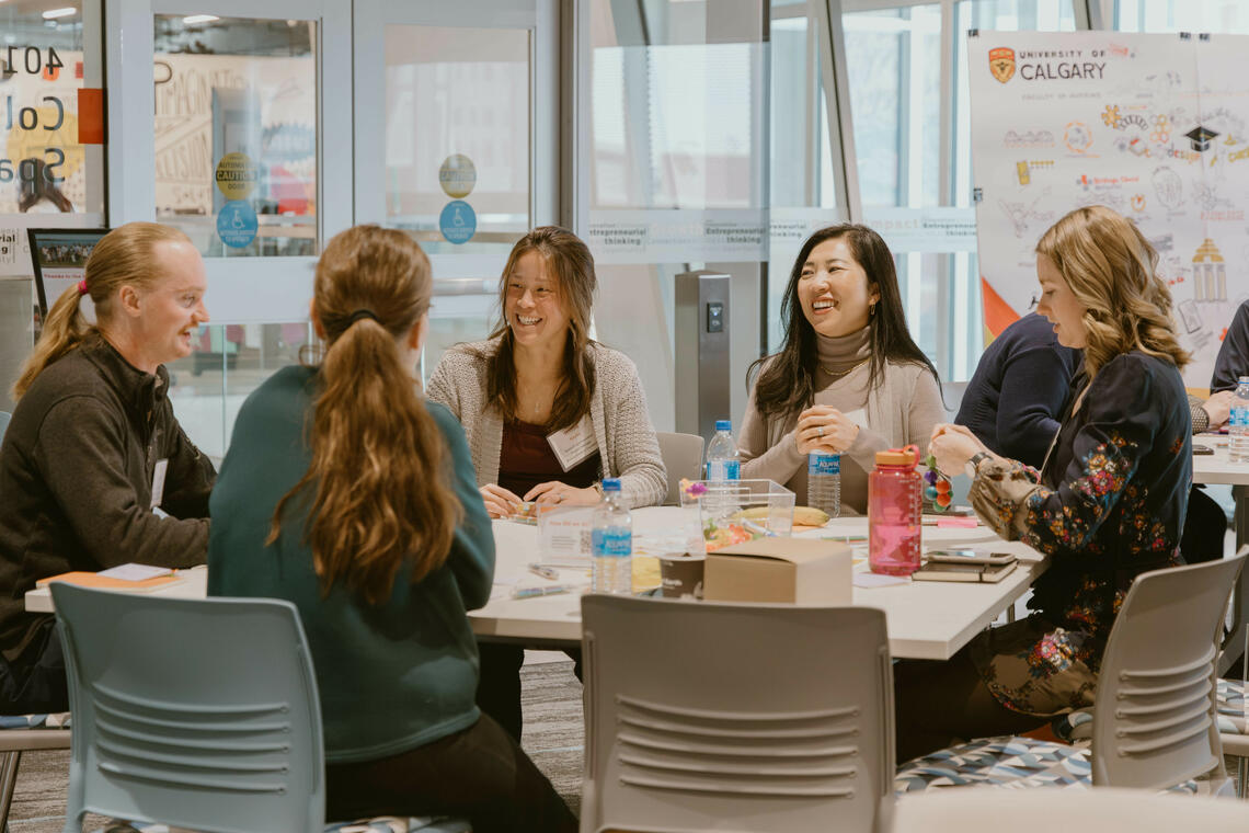 participants sitting at a table talking.