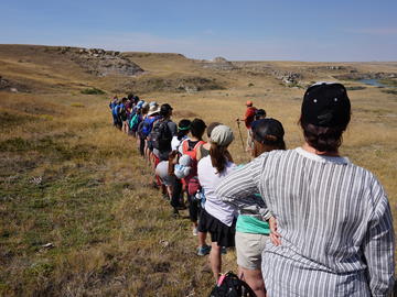 Blackfoot Elder Randy Bottle prepares the group for their hike into the restricted lands at Writing-on-Stone