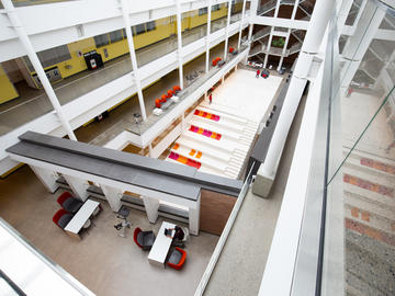 The Schulich School of Engineering atrium is empty except sanitation staff and one student.