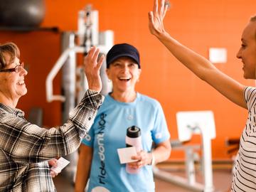 Participants high five in cancer and exercise program in the Thrive Centre