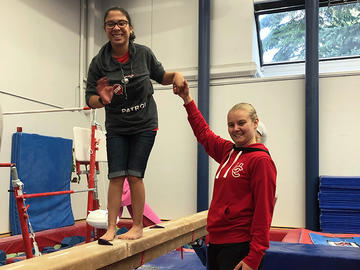 Adapted camp participant on balancing beam