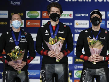 Ted-Jan Bloemen, Jordan Belchos, and Connor Howe celebrate their Silver medal on the podium of the Men’s Team Pursuit at the ISU World Speed Skating Championships in Heerenveen, the Netherlands, Friday, Feb. 12, 2021.