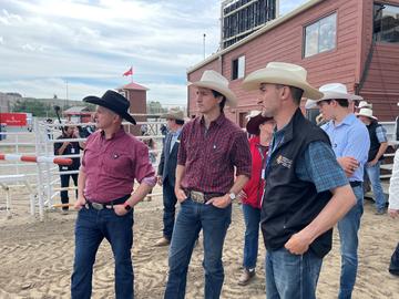 Renaud Léguillette (right) talks with Trudeau about his extensive research to improve the health, safety and performance of horses at the Stampede. UCalgary photo