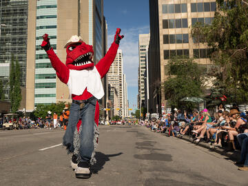 Rex revs up the crowd during the Stampede Parade.