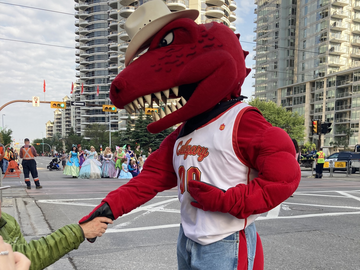 Rex shaking hands with a man attending the parade.
