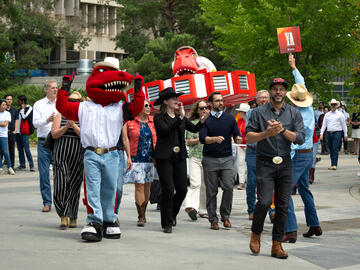 Chancellor Jon Cornish along with Rex, lead the new float to be revealed to the university community at the President's Stampede BBQ.