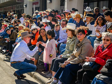 President Ed McCauley talking with UCalgary community members at the Stampede Parade. 