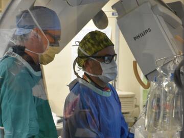 Three surgeons perform an operation