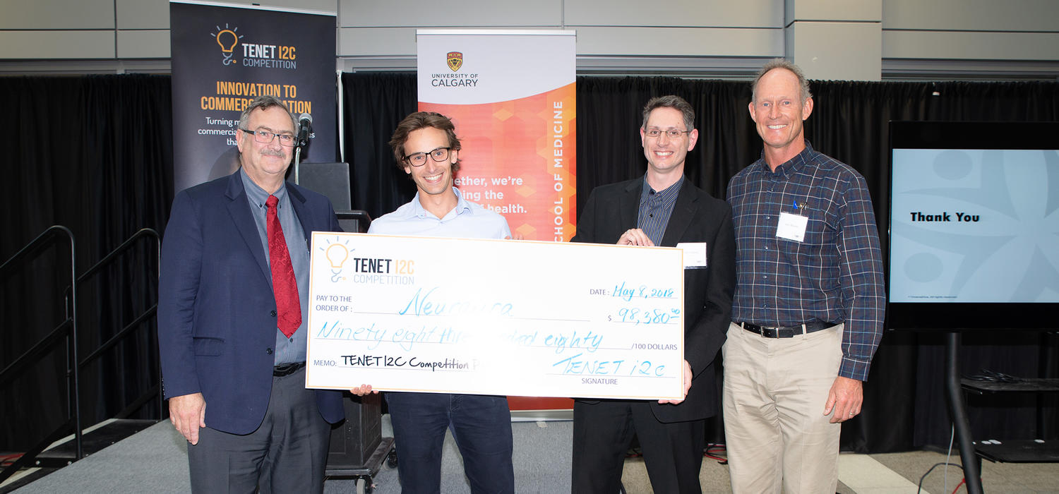 First-place team Neuraura was presented with the prize cheque at the 2018 TENET i2c competition finals on May 8. From left: Jon Meddings, dean of the Cumming School of Medicine; Pierre Wijdenes and Colin Dalton of Neuraura; and competition founder Ken Moore.