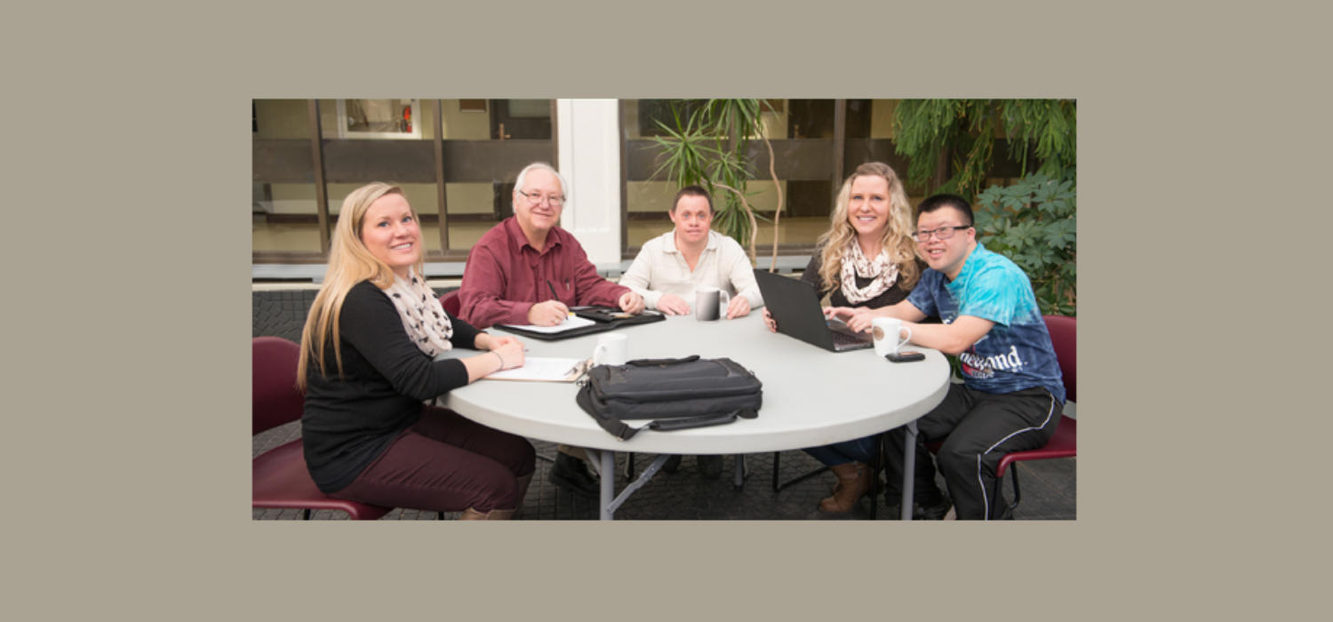 Vecova consumers and staff sitting around a table