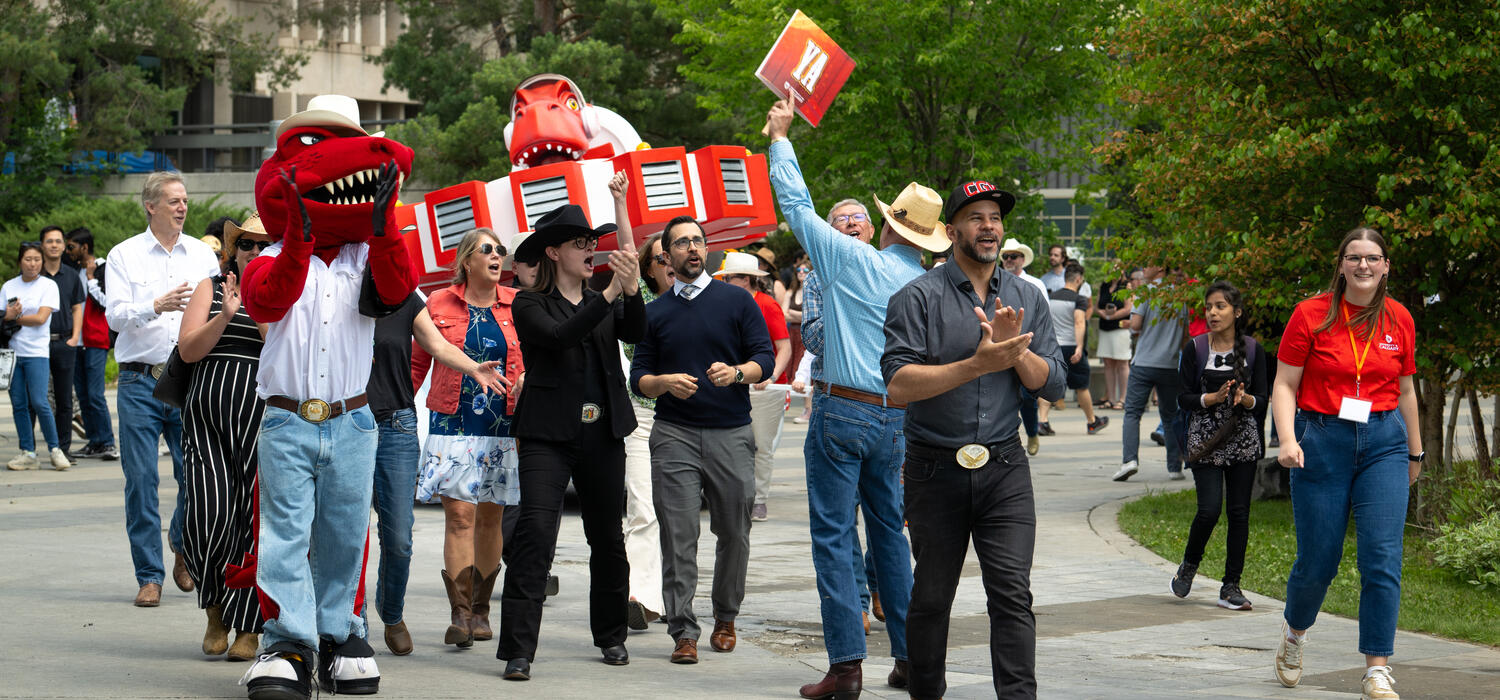UCalgary Chancellor Jon Cornish marching with volunteers at the Presidents Stampede Barbecue
