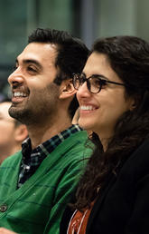 Ashkan Tehrani and Negar Mohammadi look on during the award ceremony at the Innovation4Health Hack Competition.