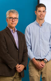 Drs. David Eaton and Thomas Eyre pictured in front of a diagram demonstrating the "slow slip" process.