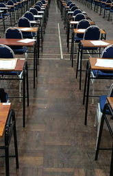 desks with exam papers