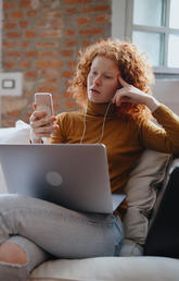 Woman on laptop and phone