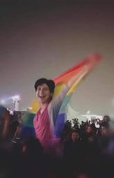 arah Hegazi raises the rainbow flag at a concert in Cairo in 2017. 