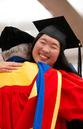 Emily Chen embraces Dick Haskayne at the 2023 Convocation