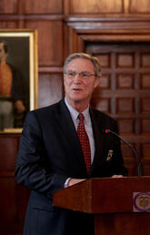 A man stands behind a podium