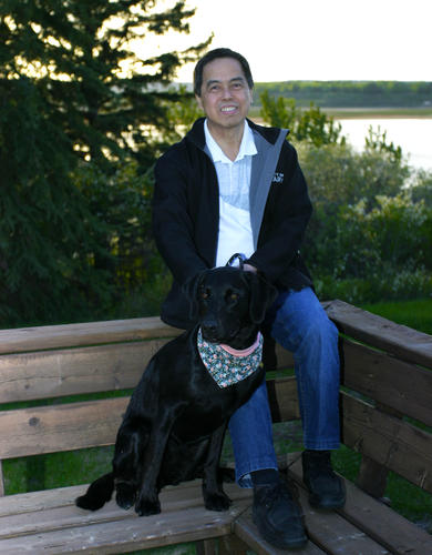 Dr. Bernie Law, PhD with his dog Savannah.