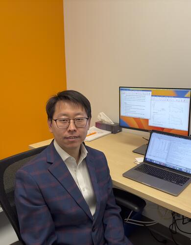 Data scientist Dr. Guosong Wu sits by his computer in the Centre for Health Informatics.