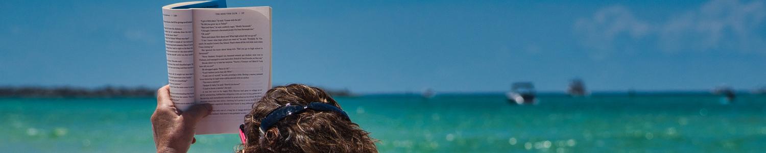 Person reading on beach