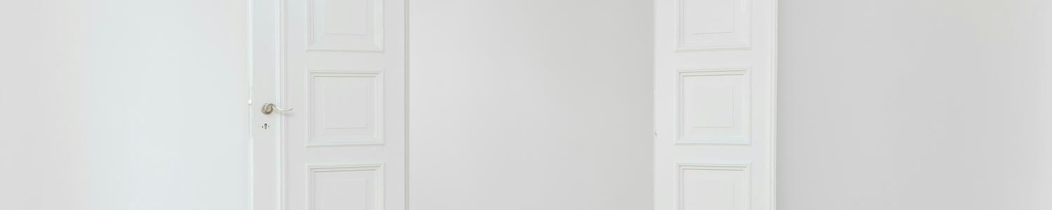 White door open against a white wall