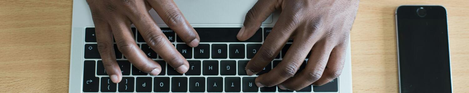 Man typing on keyboard