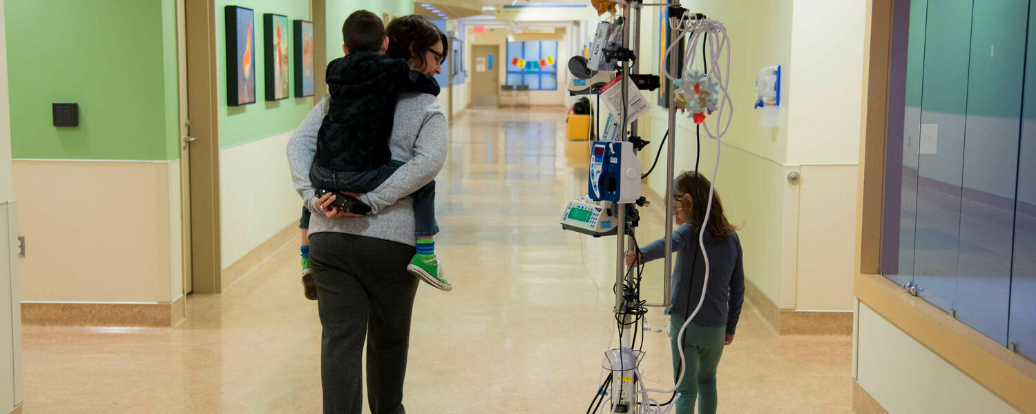 Patient and family walking down hospital hallway