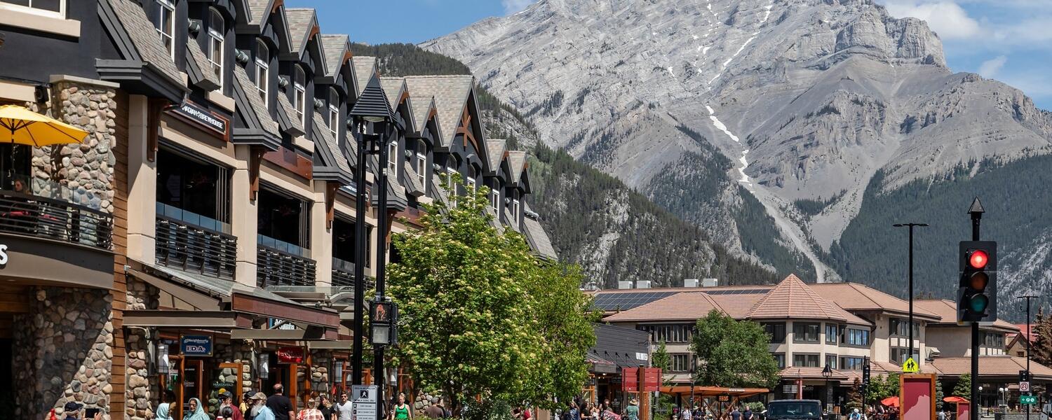 People walking and driving through the streets of downtown Banff. Alberta