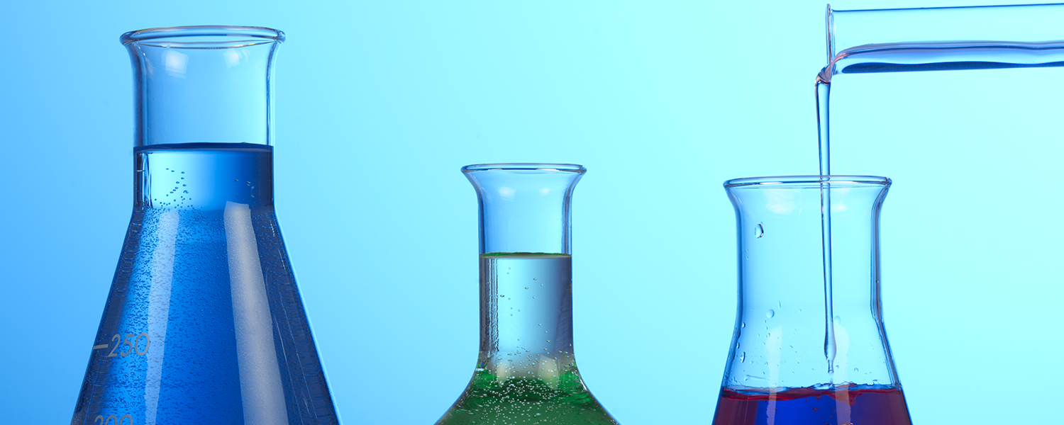 Three beakers filled with fluid. 