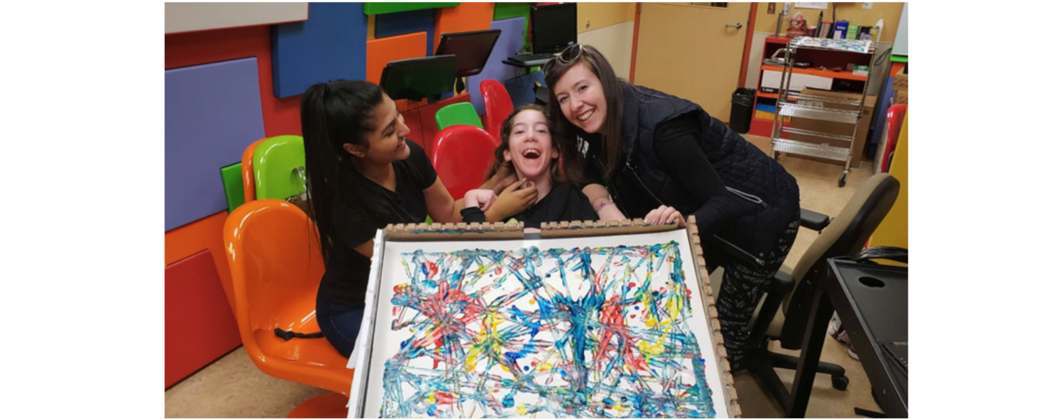 Young girl displaying a painting she made with BCI