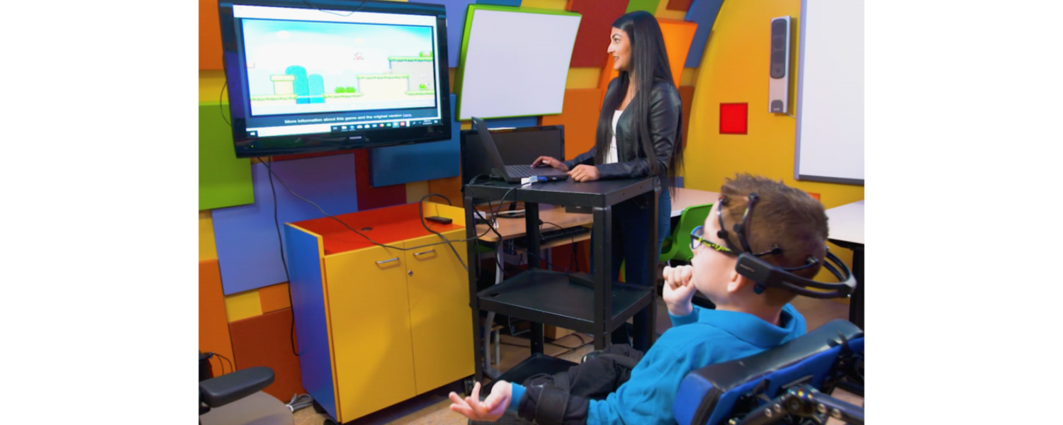 A boy playing a video game with a BCI