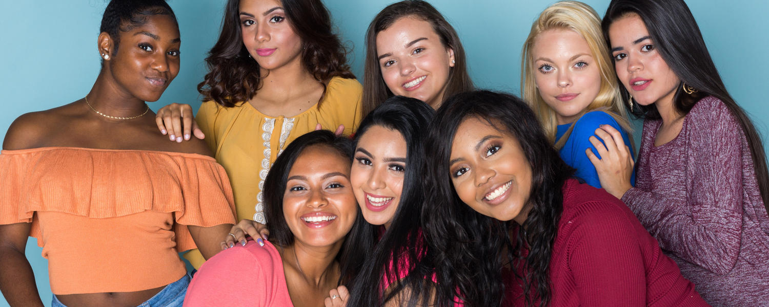 Group of teenage girls smiling and posing for photograph