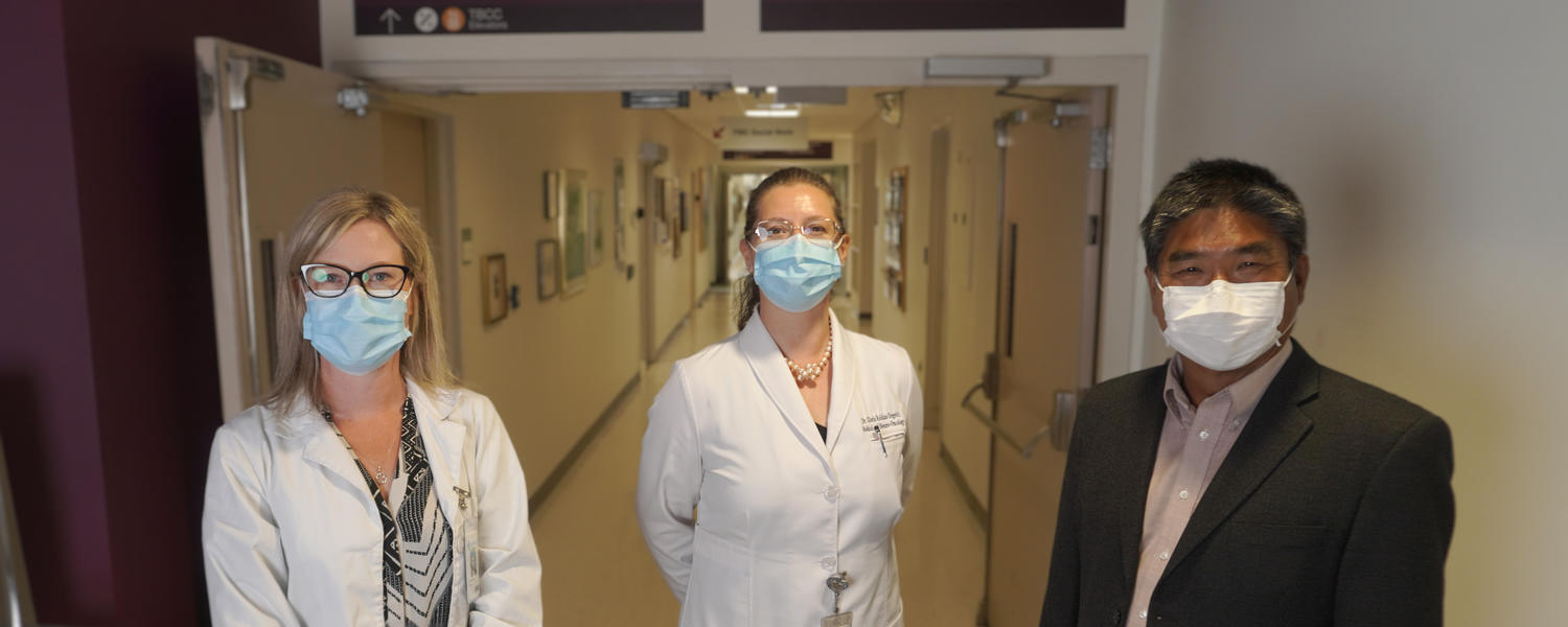 Dr. V. Wee Yong (right), with Dr. Paula de Robles (left) and Dr. Gloria Roldan Urgoiti at the Tom Baker Cancer Centre.