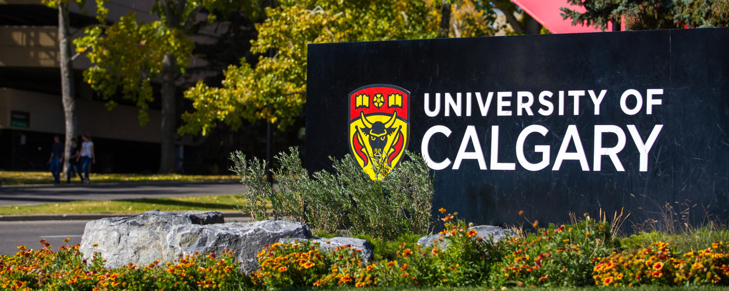 Photo of the U of C sign under the red arch on main campus