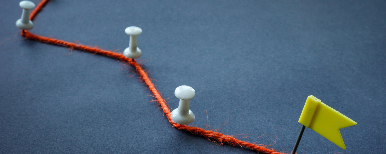 A string with multiple pins leading to a flag