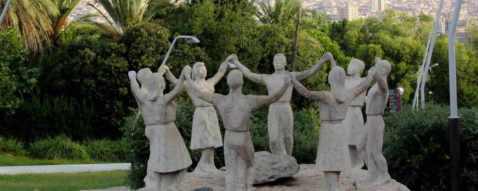 The image is of a stone sculpture of a group of standing people, hands raised and joined in a circle; it is both joyous and just a smidgen distrubing. "Lets Join Hands" by Jocey K is licensed with CC BY-SA 2.0. To view a copy of this license, visit https://creativecommons.org/licenses/by-sa/2.0/ 